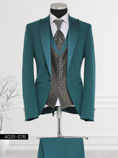 Luxury teal green suit featuring a satin shawl lapel, single-breasted patterned waistcoat, tailored trousers, and satin cravat displayed on a mannequin