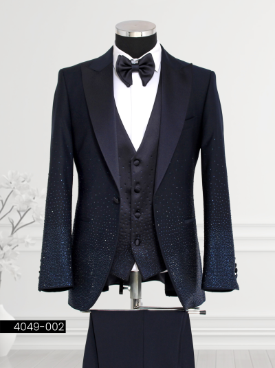 Midnight Blue Tuxedo with Satin Lapel and Gradient Crystal Detailing featuring a satin shawl lapel, double-breasted patterned waistcoat, tailored trousers, and bow tie displayed on a mannequin