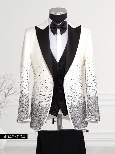 White Suit with Black Satin Lapel and Gradient Crystal Detailing featuring a satin shawl lapel, double-breasted black patterned waistcoat, tailored trousers, and bow tie displayed on a mannequin