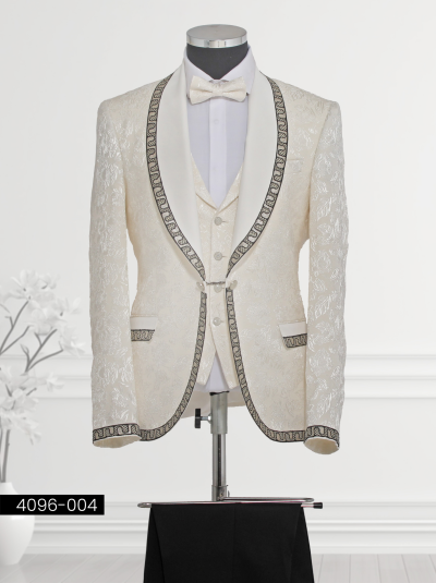 Elegant white brocade tuxedo featuring black chain-like trim on the satin shawl lapel and cuffs, paired with matching waistcoat and tailored trousers.