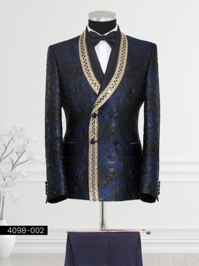 Navy blue double-breasted tuxedo for men with gold geometric trim on satin shawl lapel and jacket edges.