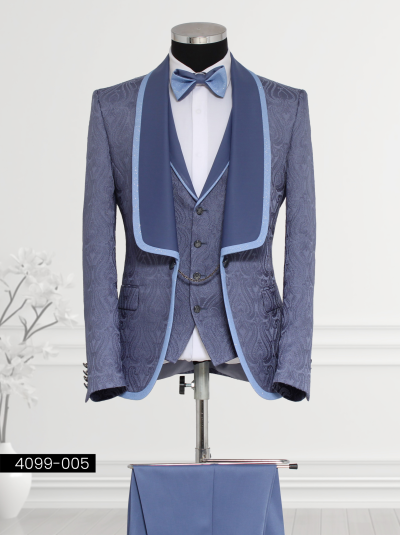 Steel blue brocade suit for men featuring paisley patterns, satin shawl lapel with shimmering light blue trim, matching waistcoat with silver buttons and chain detail, and tailored trousers.