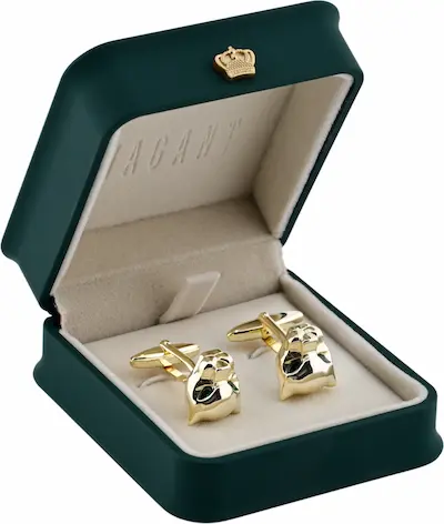 Gold fox head cufflinks in a luxurious green velvet box with a gold crown emblem, perfect for formal occasions.