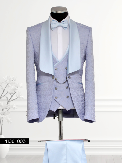 Light blue brocade formal suit for men featuring paisley patterns, satin shawl lapel blazer, matching waistcoat with silver buttons and chain detail, and tailored trousers.