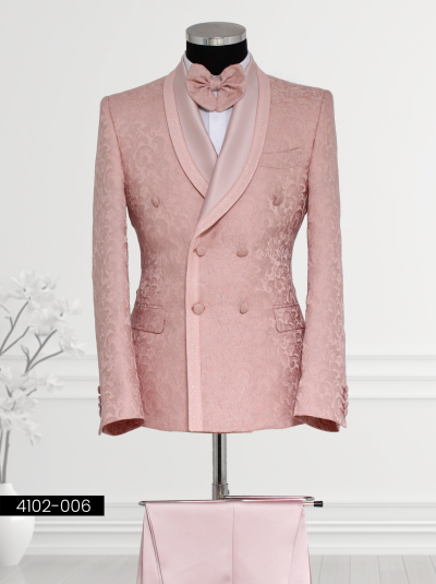 Rose pink double-breasted tuxedo featuring floral patterns, satin shawl lapel with glitter trim border, matching bow tie, and tailored trousers.
