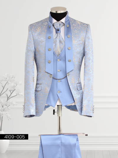 Royal blue tuxedo featuring gold embroidery, tailcoat-inspired lapel design, double-breasted waistcoat with silver buttons and chain detail, and matching trousers.