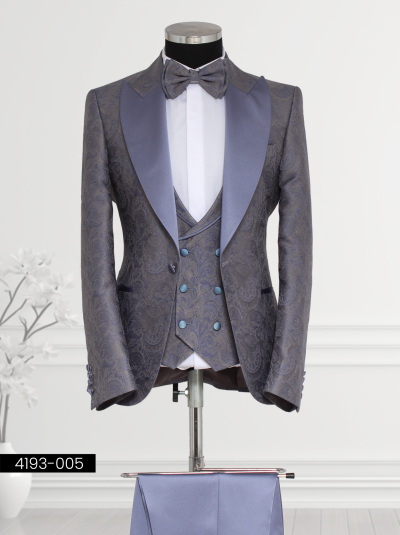 Men’s purple and blue suit with satin lapels, paisley vest, and bow tie—ideal for formal occasions.