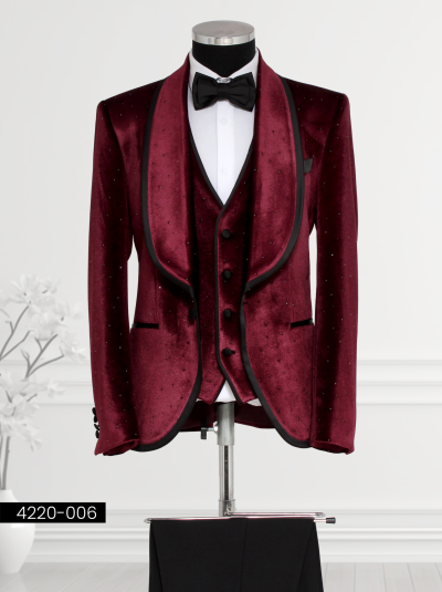 Men’s burgundy velvet tuxedo suit with satin lapels, rhinestone embellishments, velvet waistcoat, and bow tie