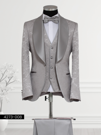 Men’s silver wedding tuxedo with satin lapels, paisley vest, and bow tie.