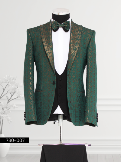 Elegant green and gold tuxedo with satin lapels, displayed on a mannequin