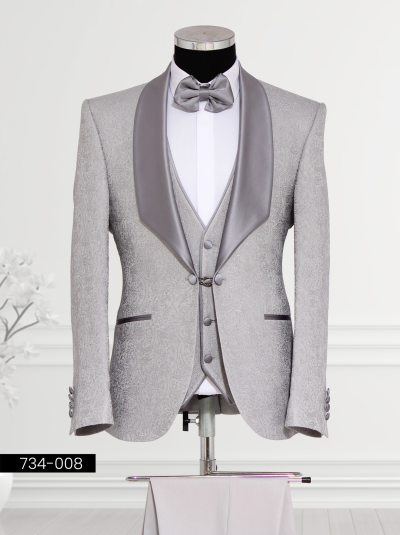 A stylish silver tuxedo with a satin lapel, waistcoat, and bow tie displayed on a mannequin.
