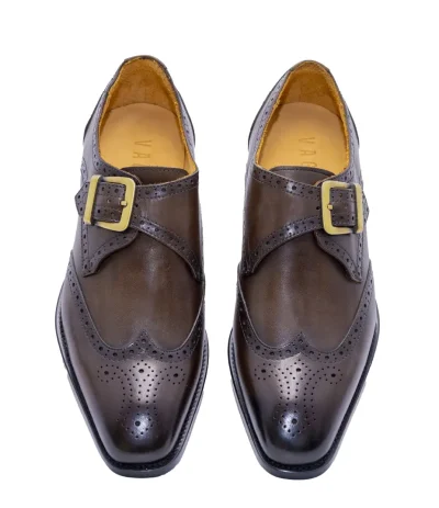 Elegant men's brown leather shoes with buckle strap and brogue detailing, ideal for formal and business events.