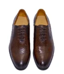 Brown men’s formal shoes with textured leather and a classic lace-up design by Vagant.