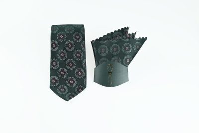 Green necktie and pocket square set with white swirls, red accents, and a gold silhouette packaging.